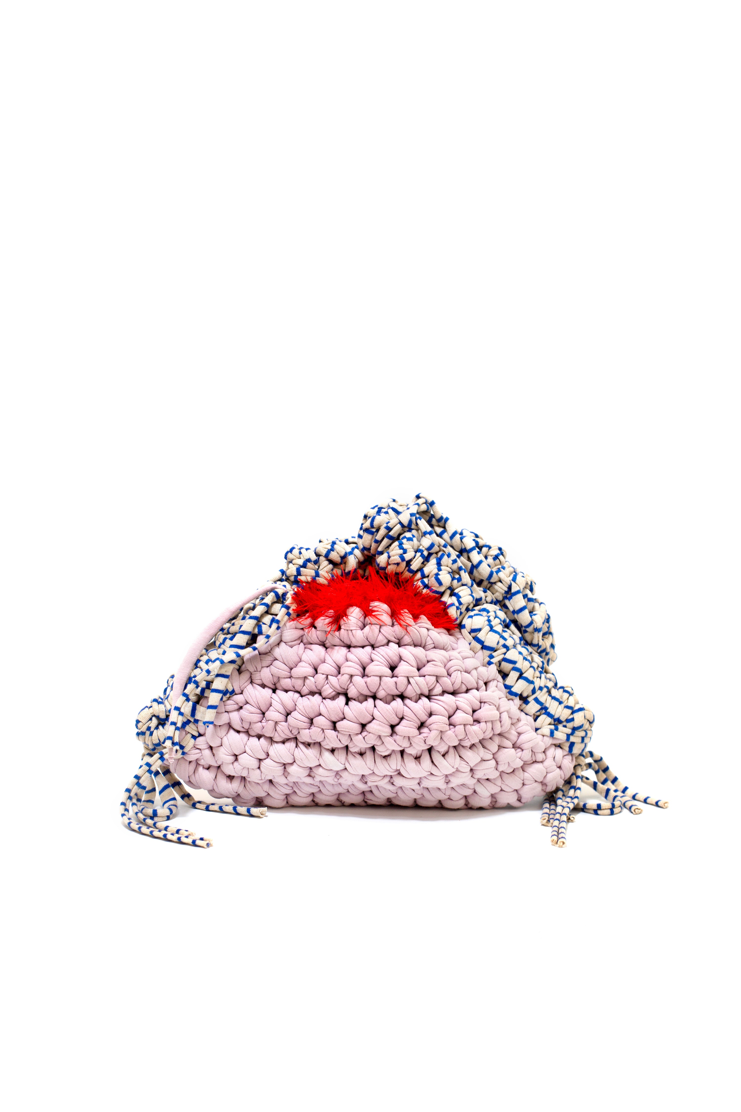 Pink knitted bag with a red interior on a white background