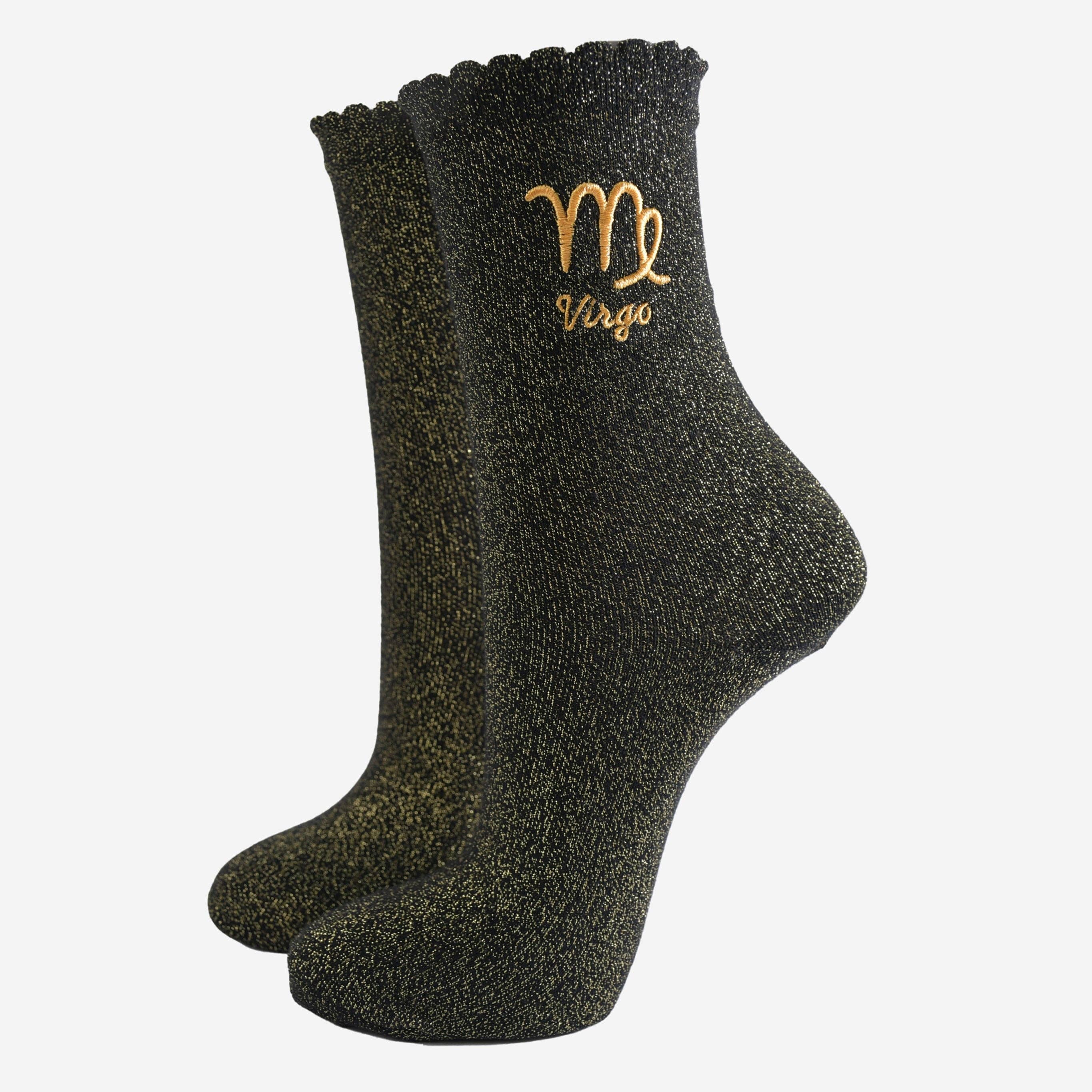Black socks with gold embroidery of a zodiac sign on a white background