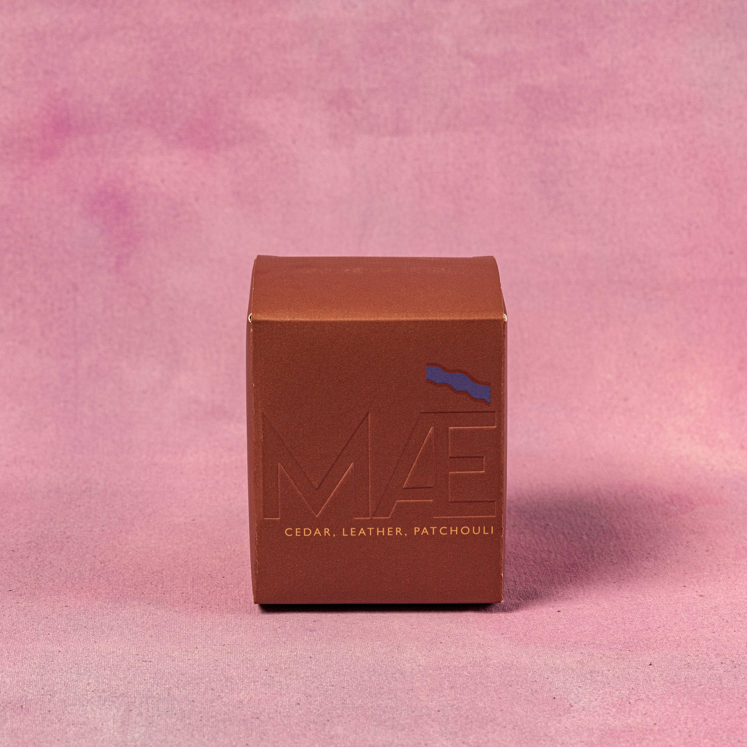 Brown box with 'MAE' branding on a pink background