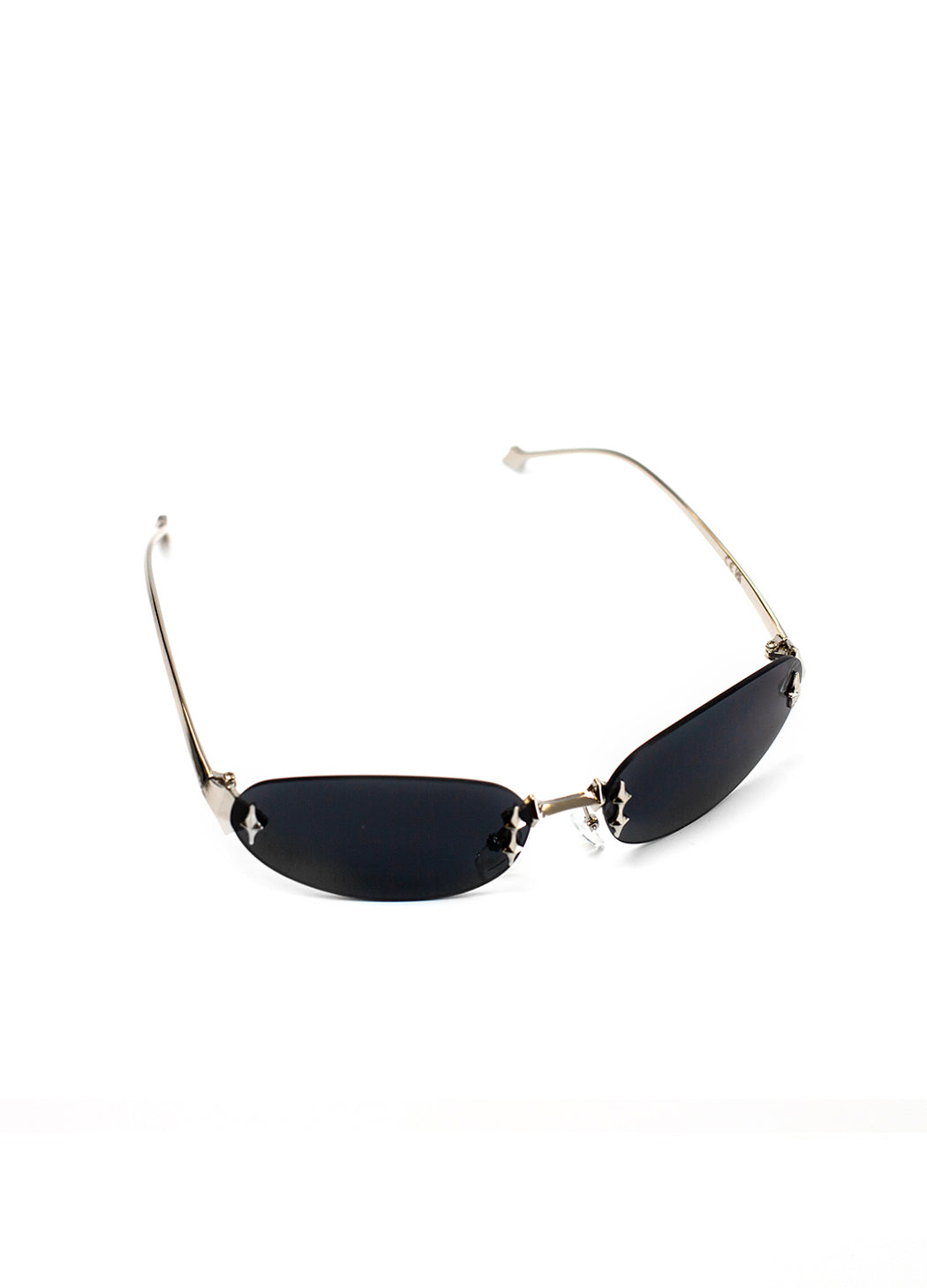 Sunglasses with black oval y2k lenses and silver frames on a white background. 