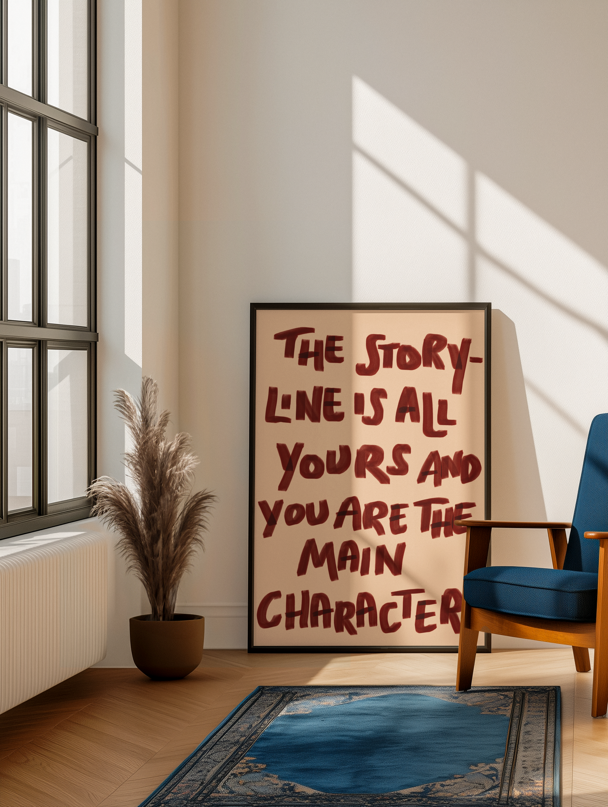 Framed motivational poster on a wall with a plant and chair in a room.