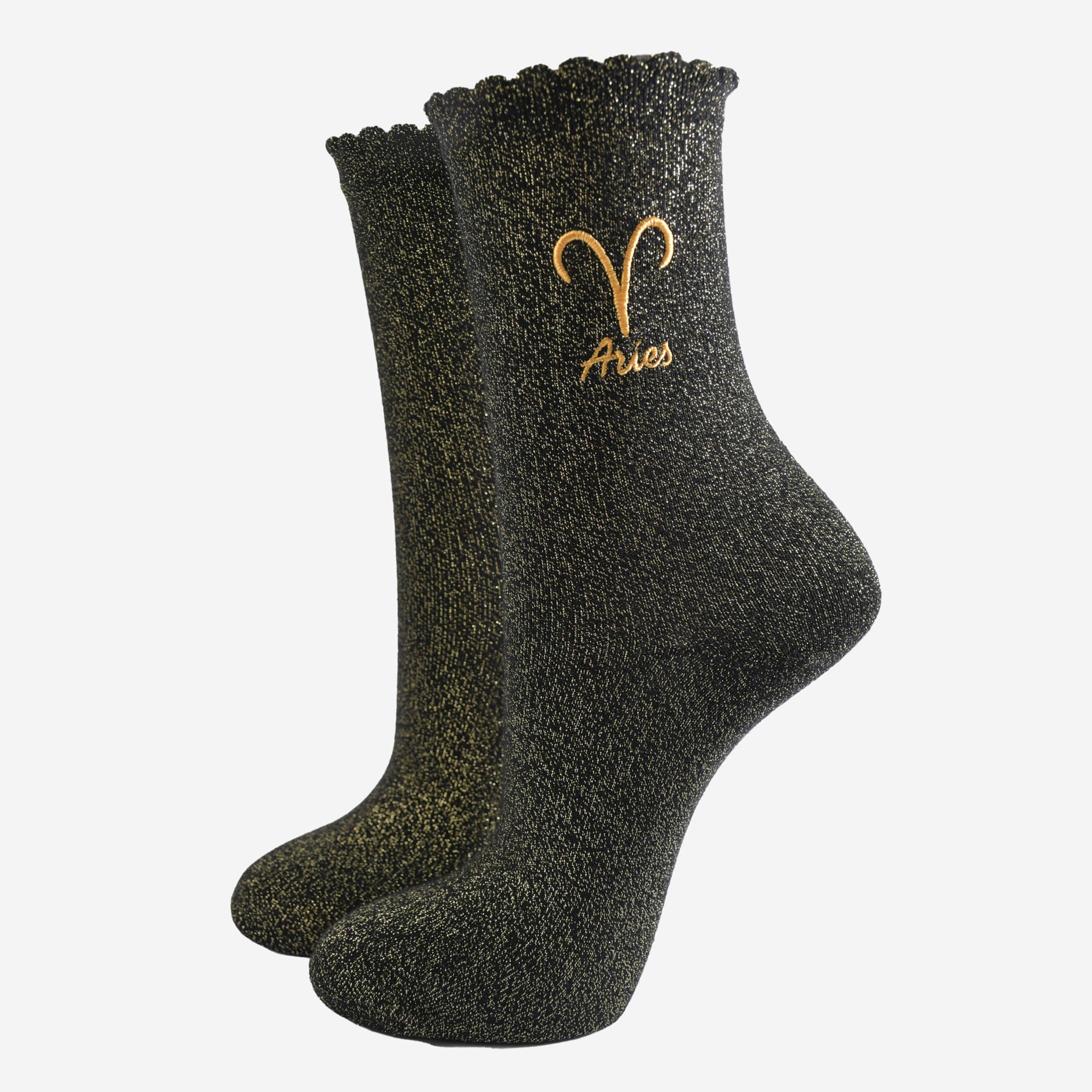 Black glittery socks with Aries symbol on a white background