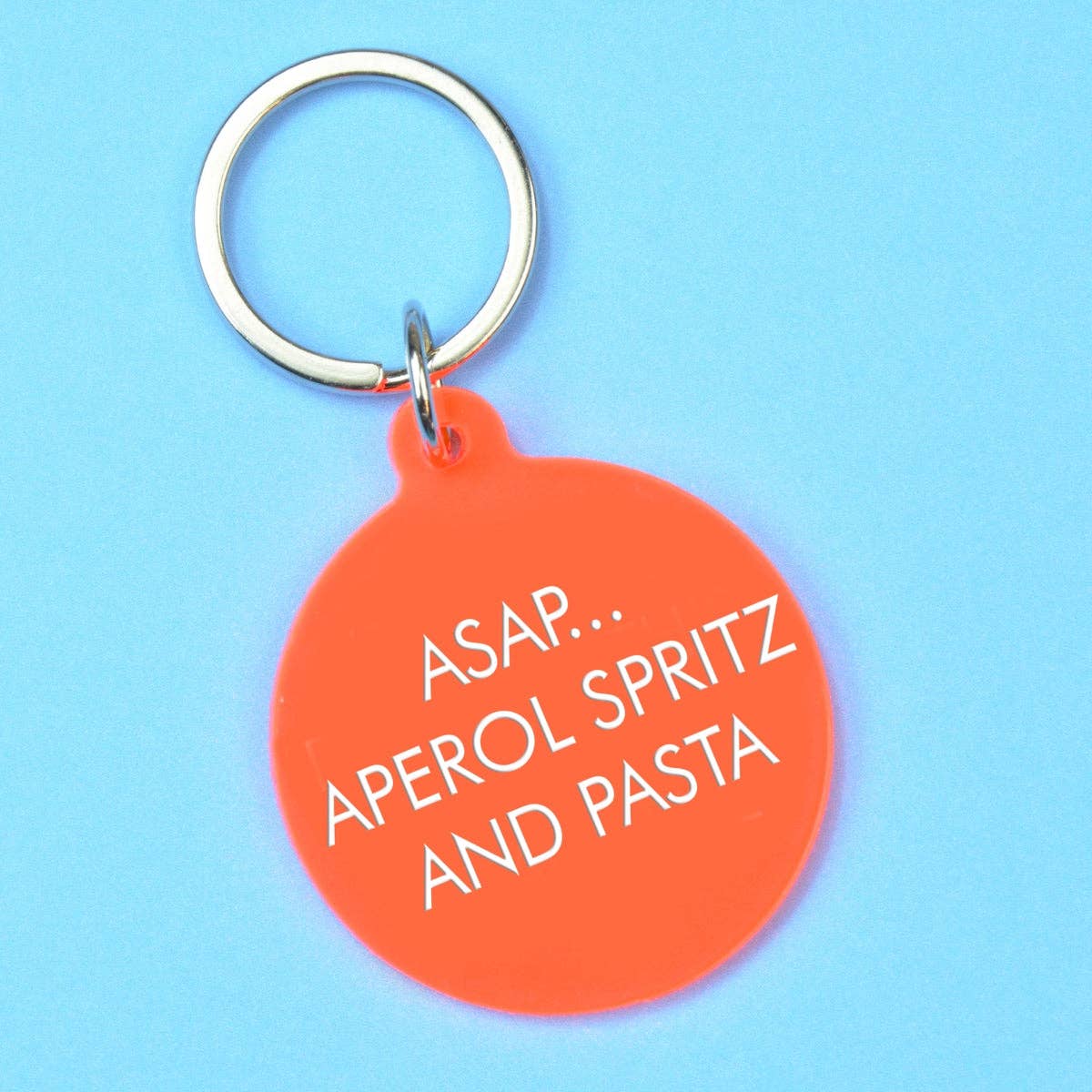 Orange keychain with 'ASAP... Aperol Spritz and Pasta' text on a blue background