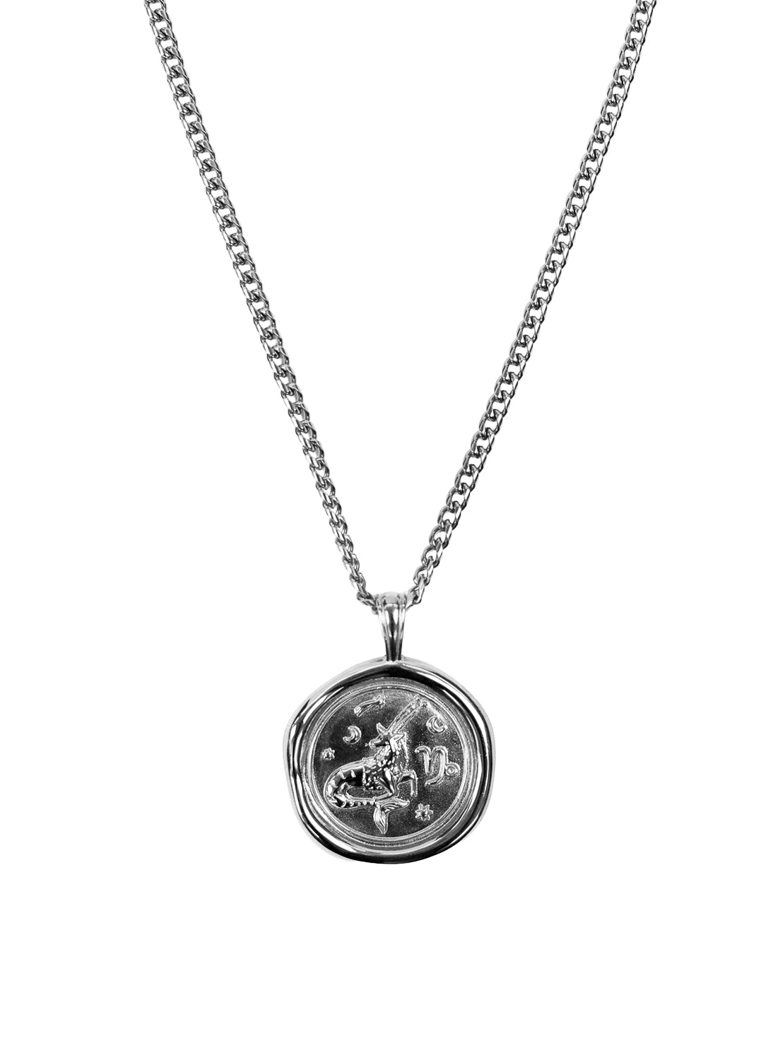 A silver-toned chain necklace with a round, faceted pendant featuring a Capricorn zodiac symbol, shown against a plain white background.