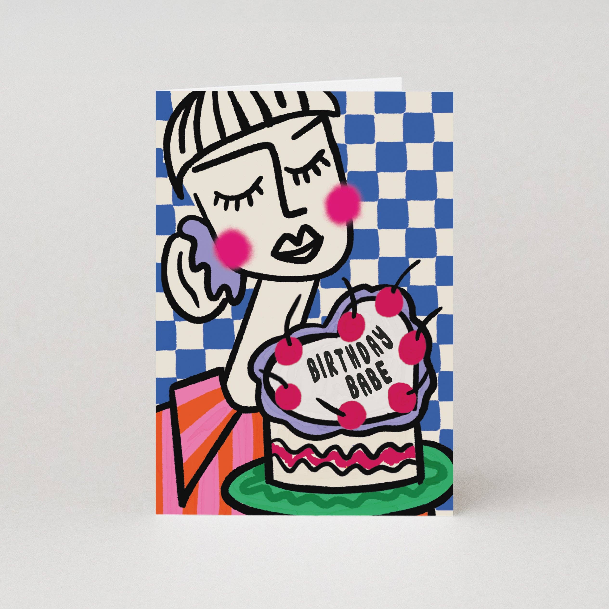 Greeting card with a stylized illustration of a woman holding a cake labeled 'Birthday Babe' on a checkered background.