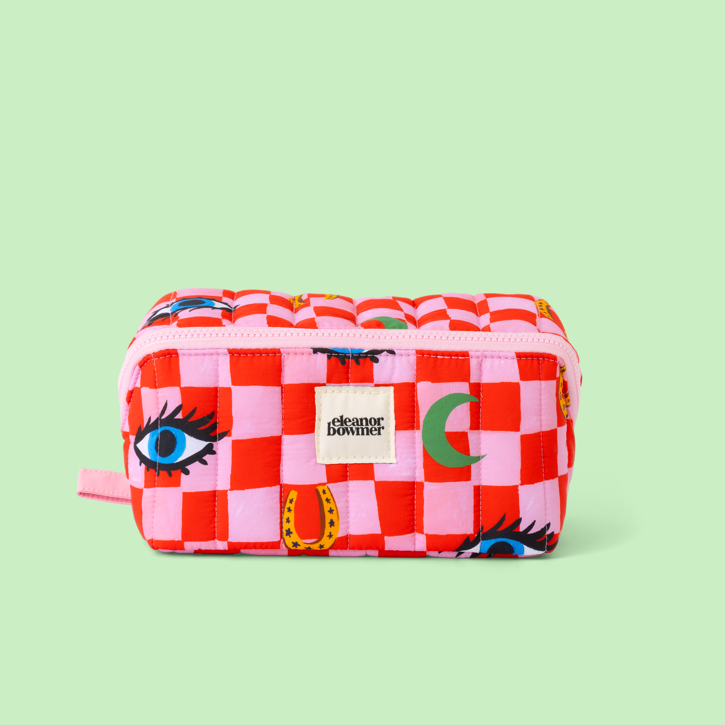 Checkered red & pink cosmetics pouch with colourful designs on a light green background