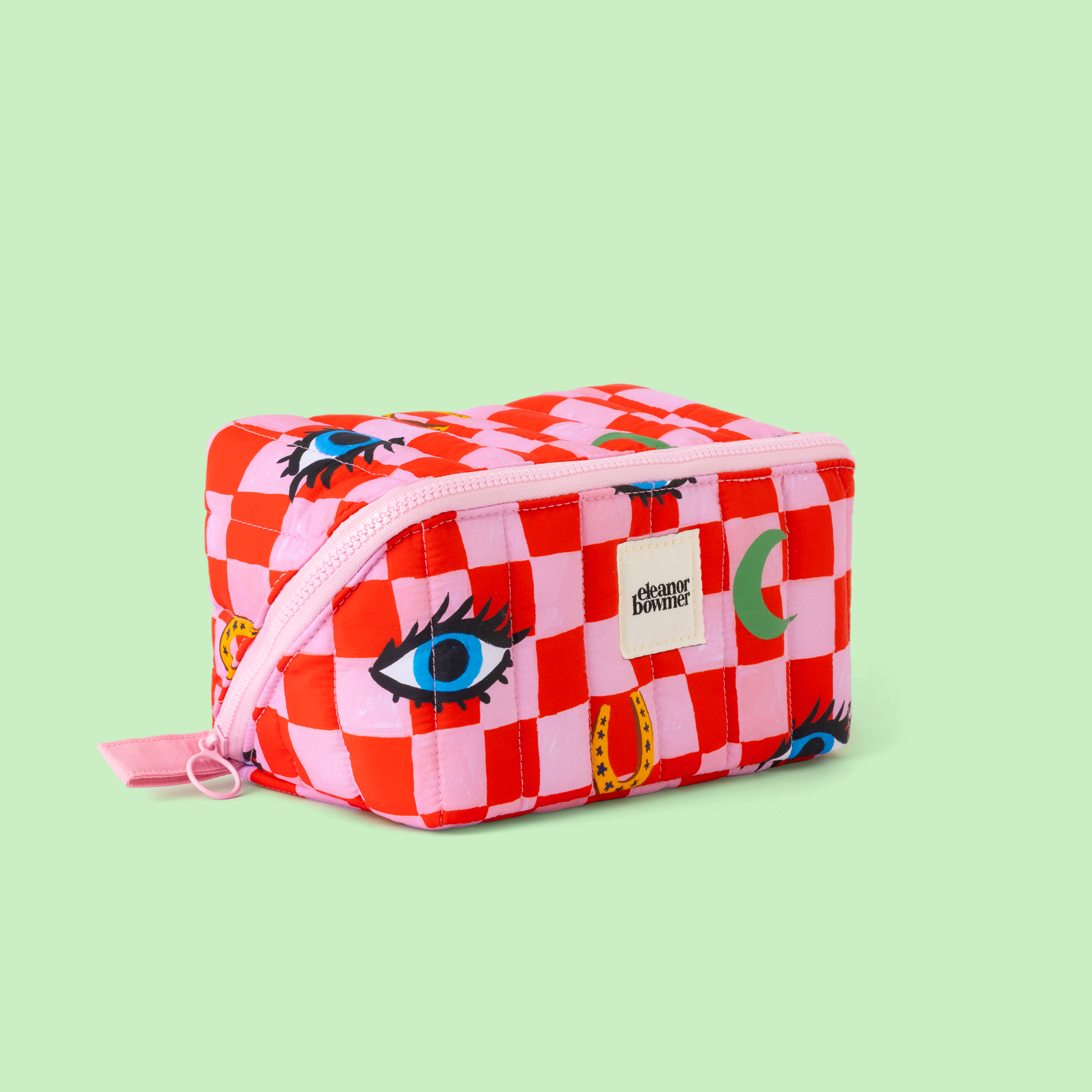 Checkered pouch with eye design on a light green background