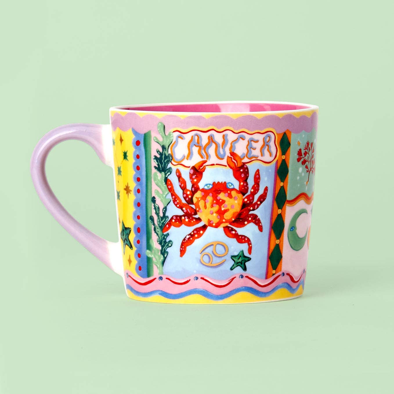 Colorful mug with a crab design and 'Cancer' text on a light green background