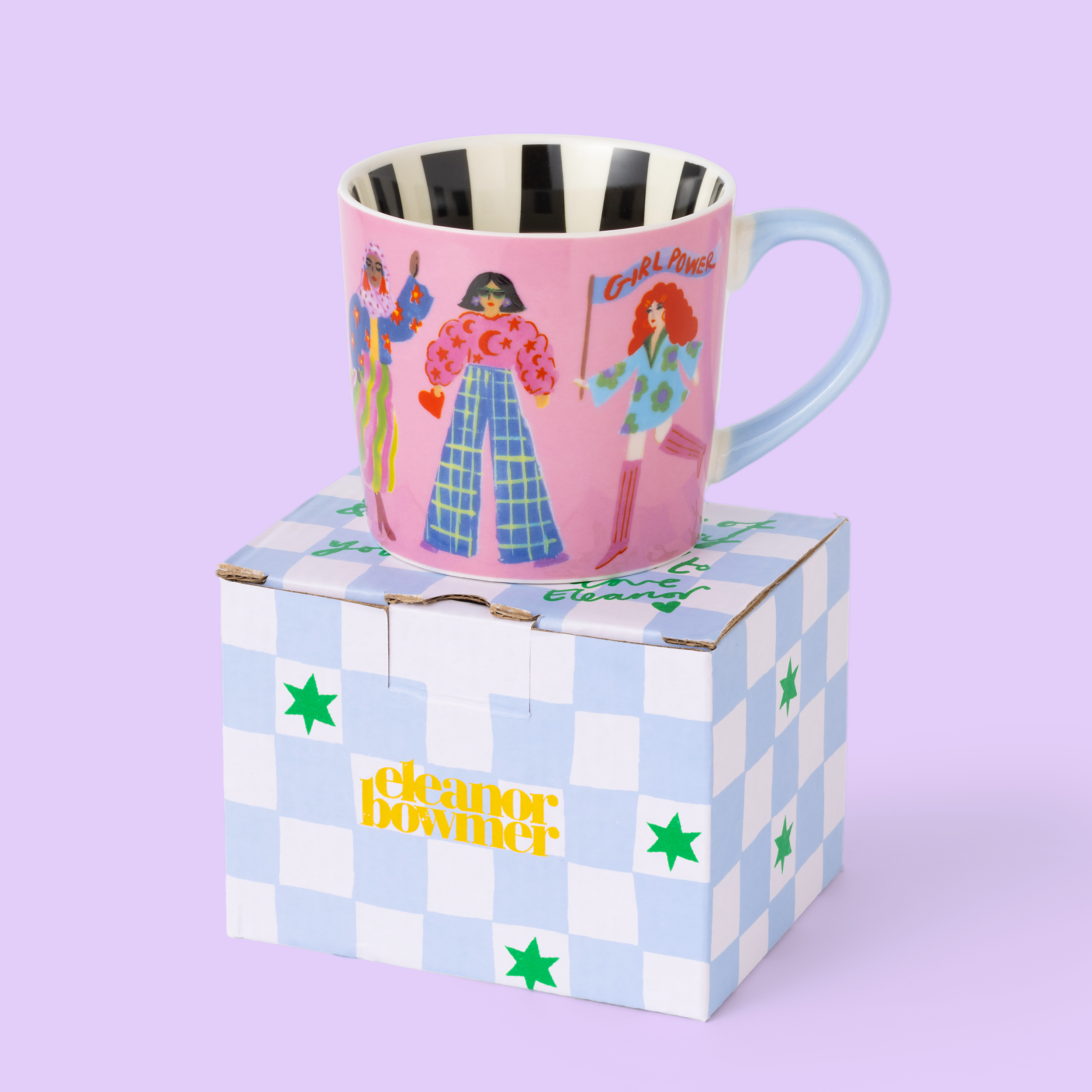 Pink mug with illustrated characters on a checkered box against a light purple background