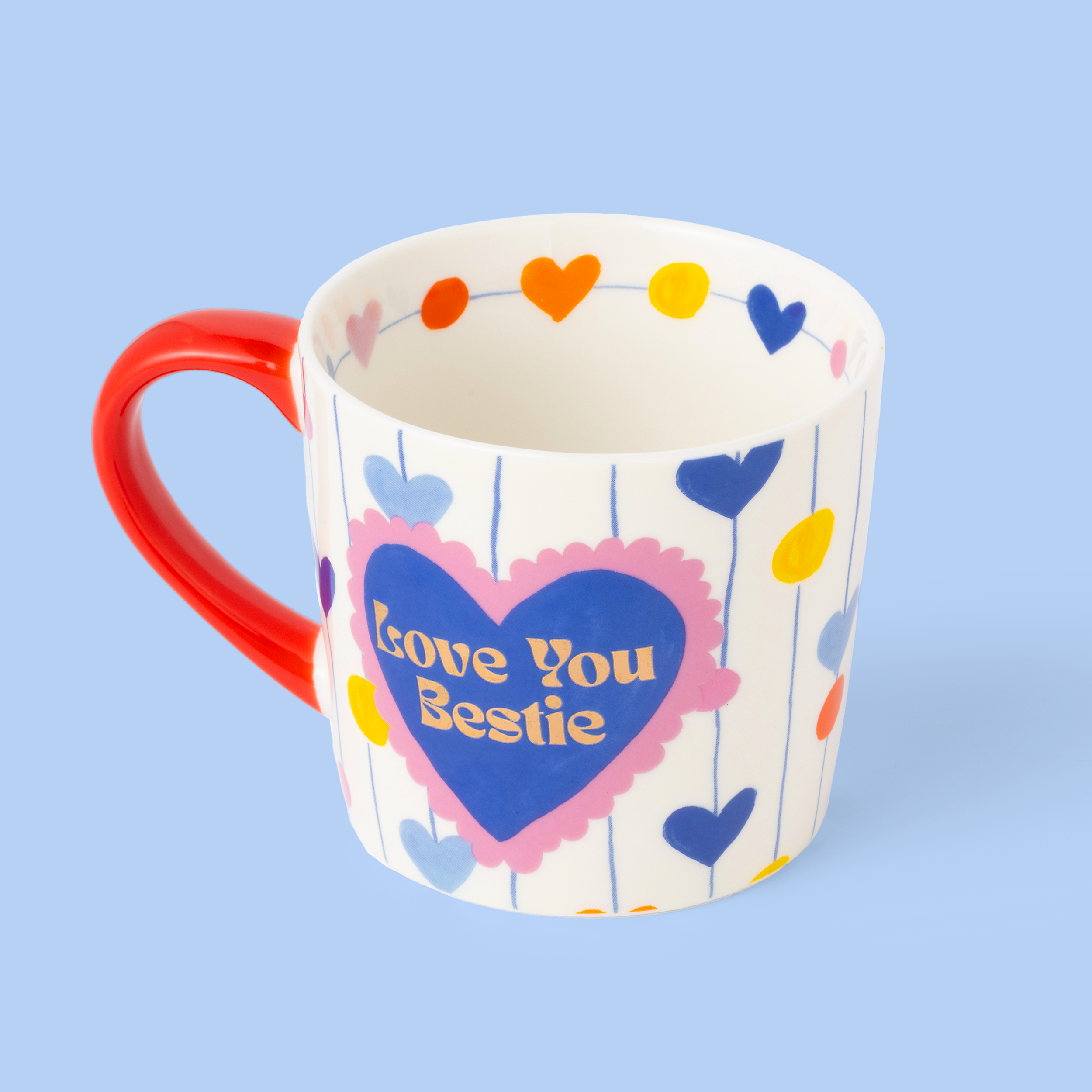 Mug with colorful heart design and 'Love You Bestie' text on a light blue background