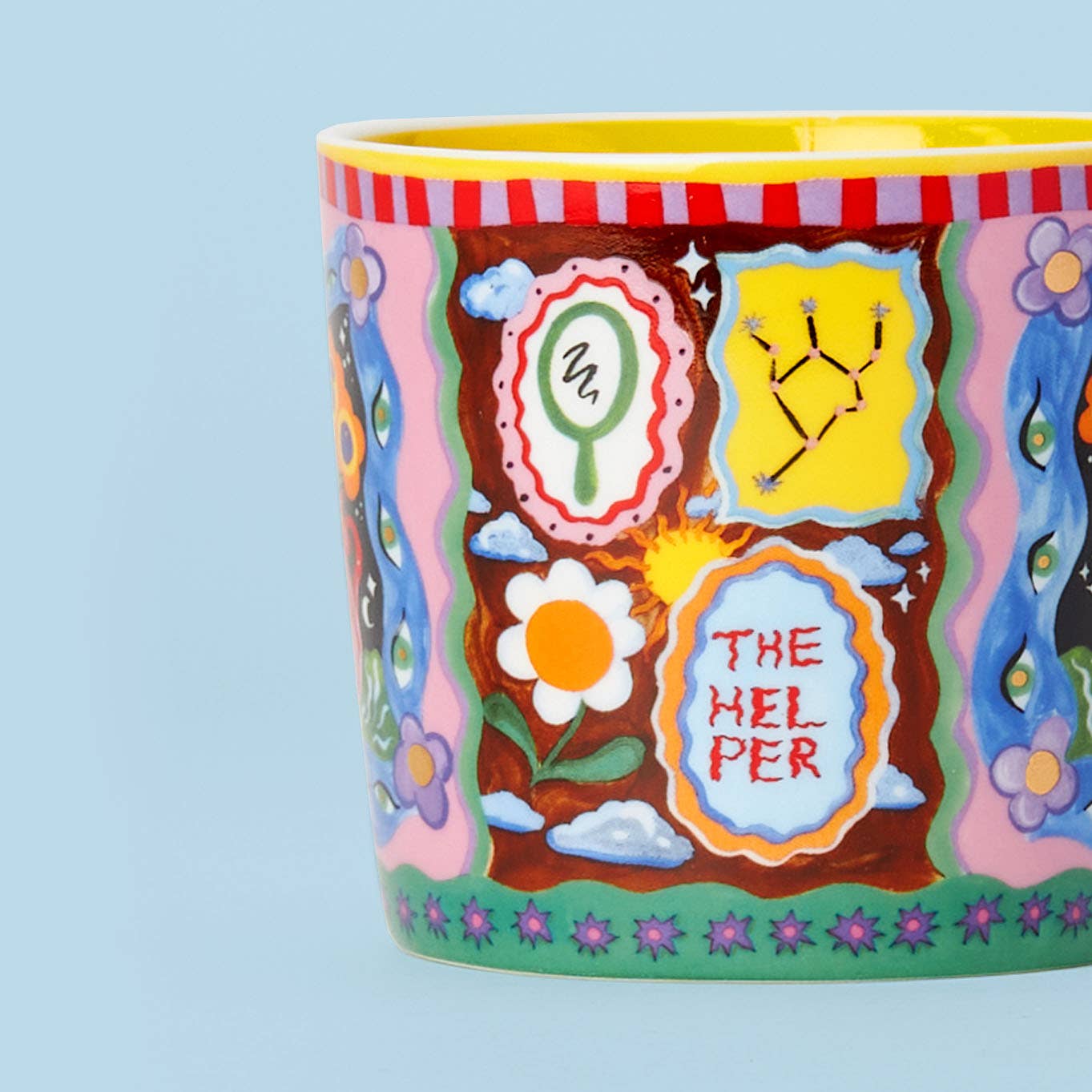 Colorful mug with artistic designs and text on a light blue background