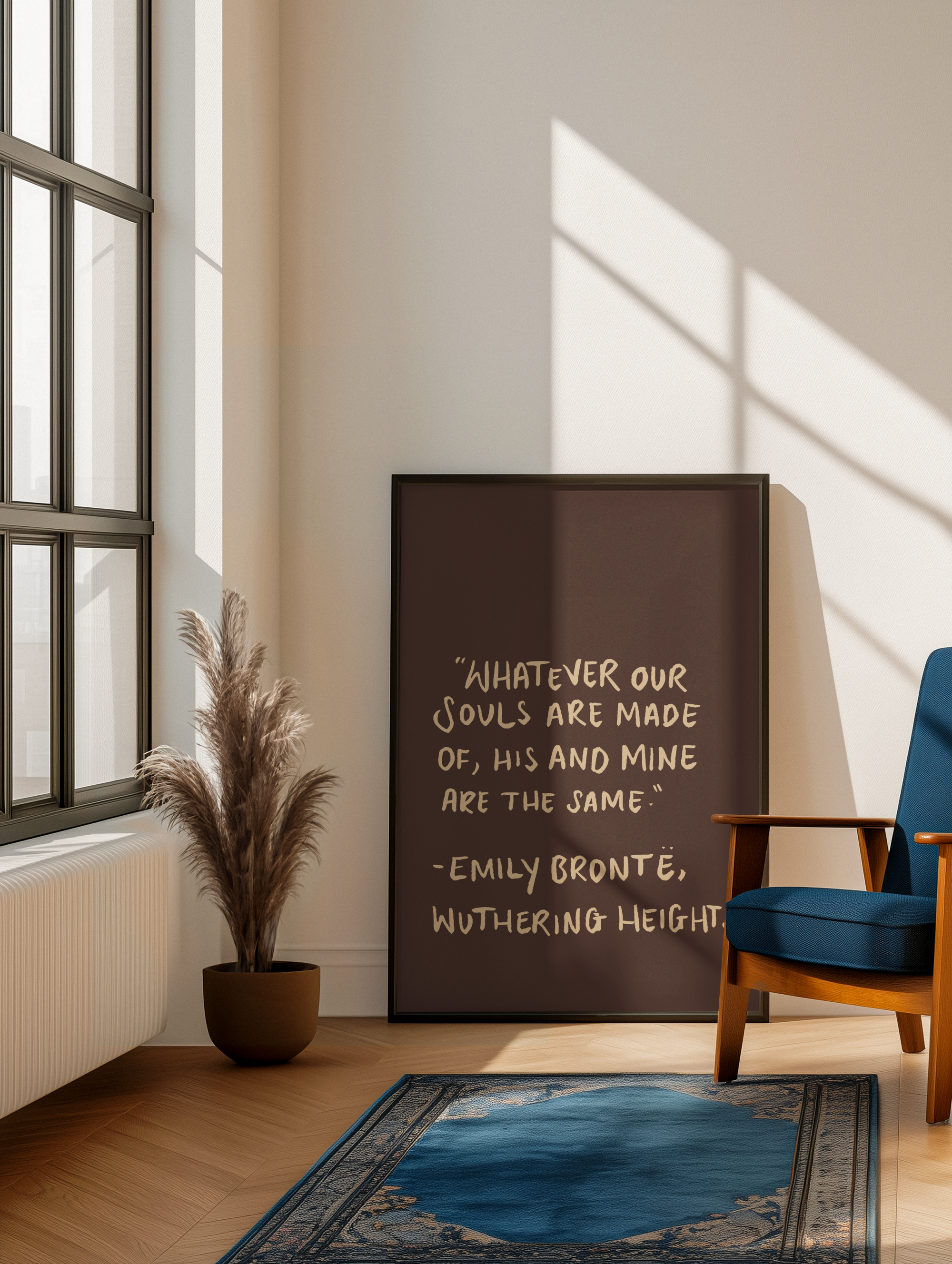 Room interior with a framed quote by Emily Bronte, a plant, and a chair.