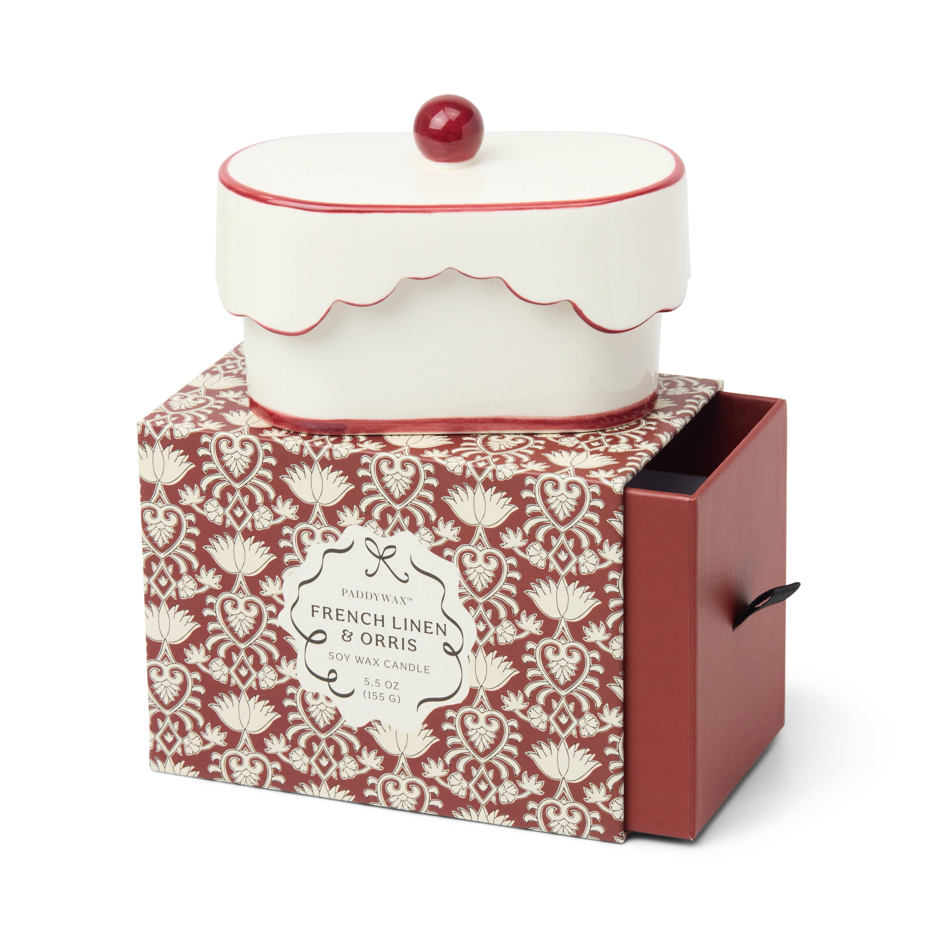Decorative candle in a patterned box with 'French Linen & Orris' label.