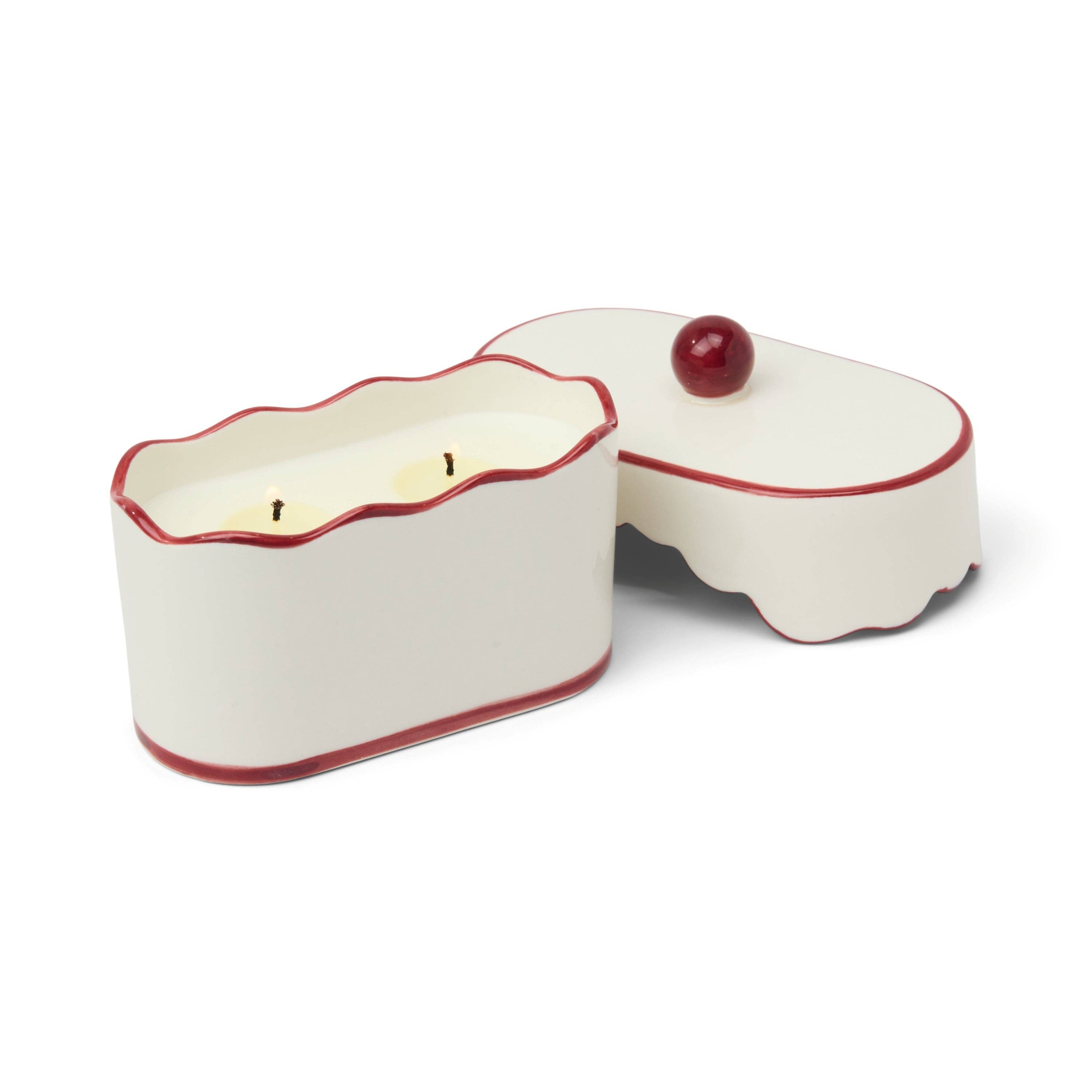 Ceramic container with a candle inside on a white background