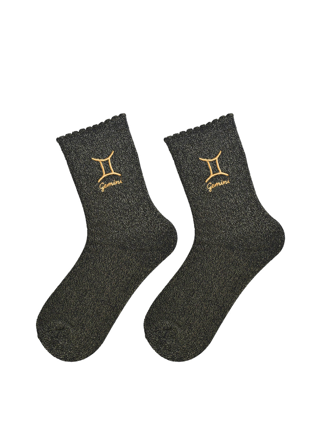 Pair of black socks with gold gemini zodiac symbols on a white background