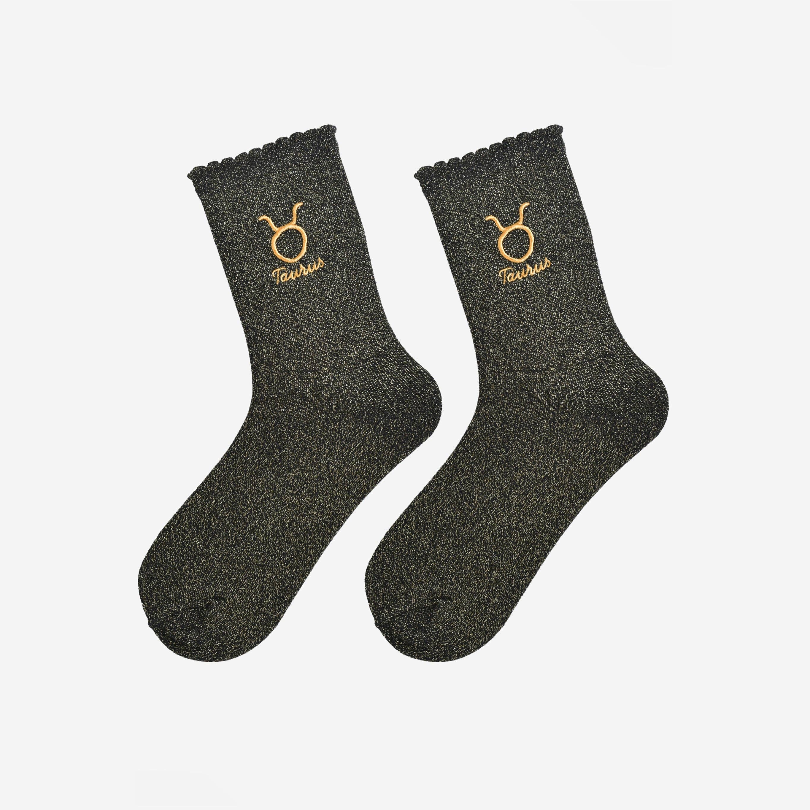 Pair of dark gray socks with gold embroidered design on a light gray background