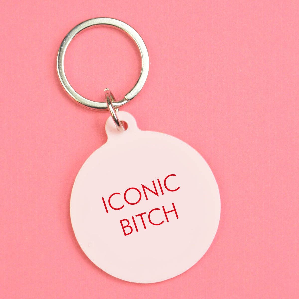 Keychain with 'ICONIC BITCH' text on a pink background
