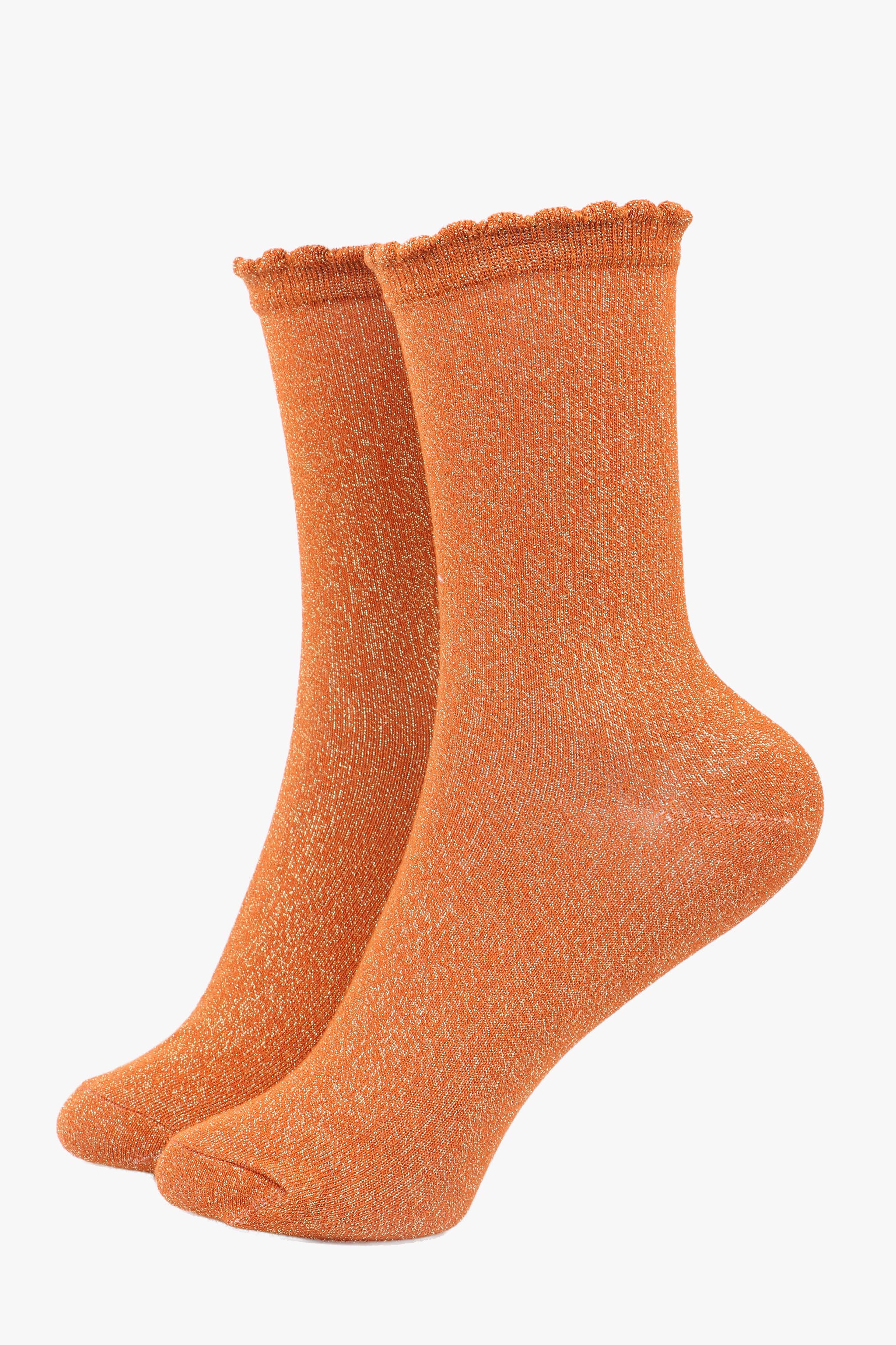 Pair of orange socks on a white background