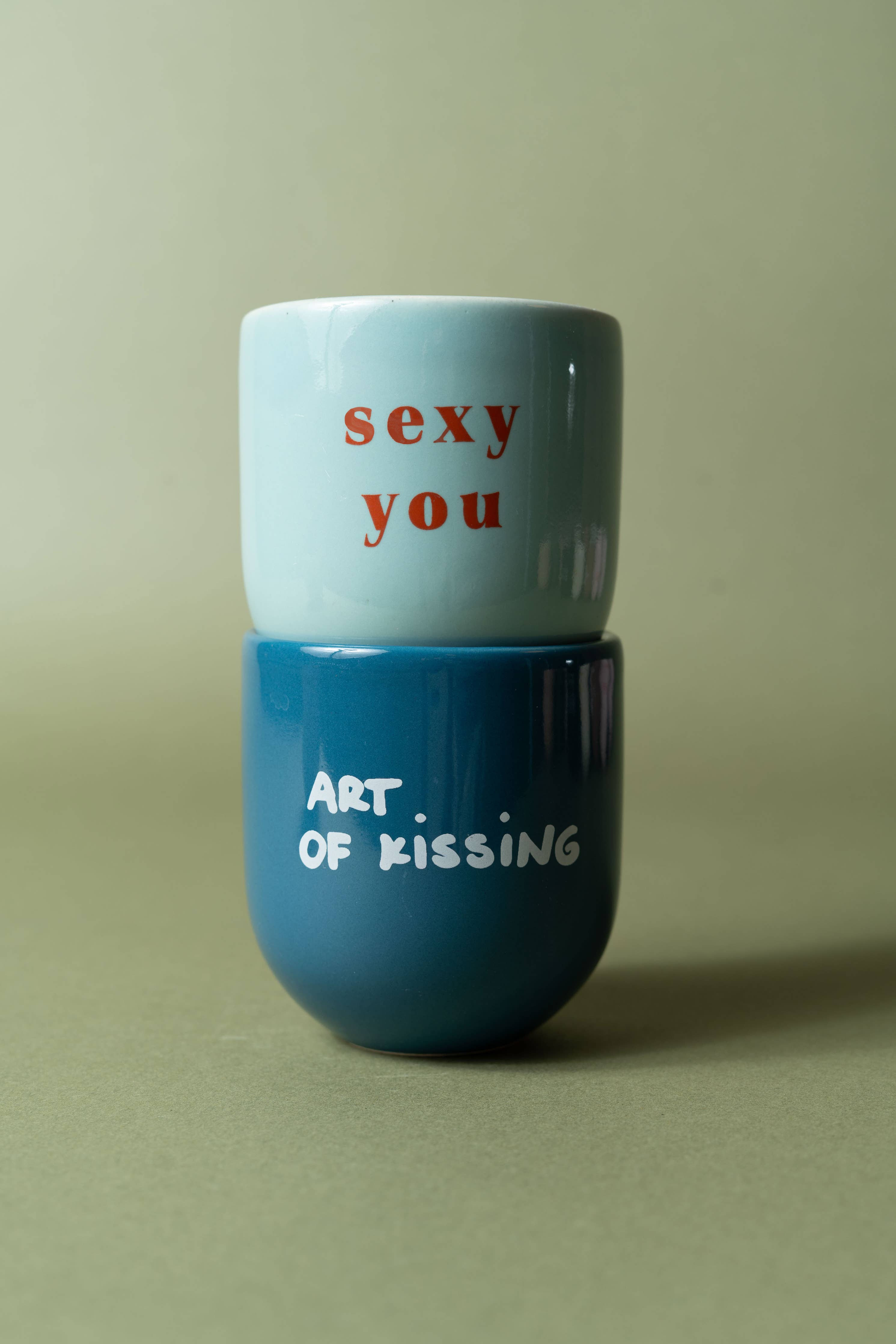 Two stacked cups with text on a plain background