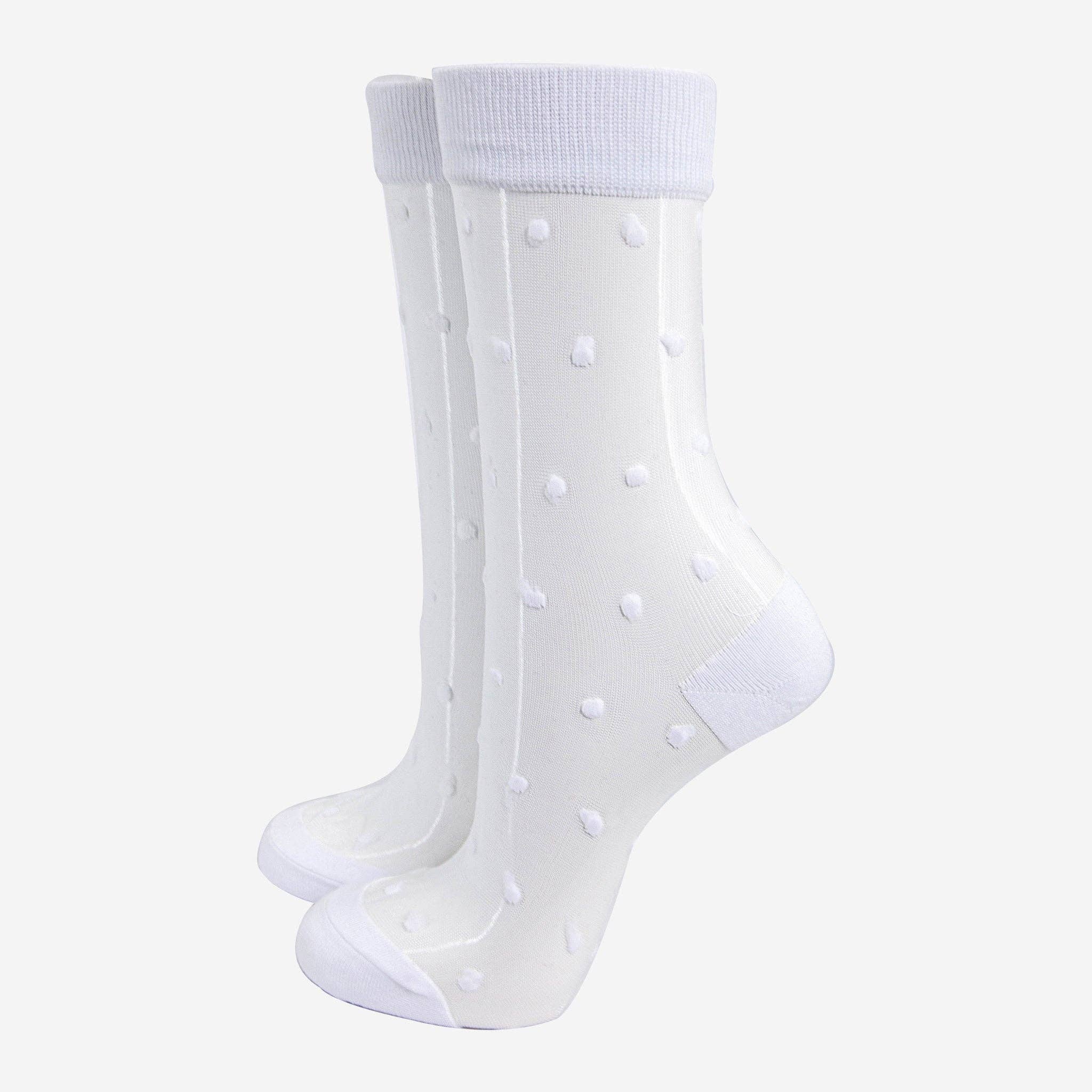 White sheer socks with polka dots on a white background