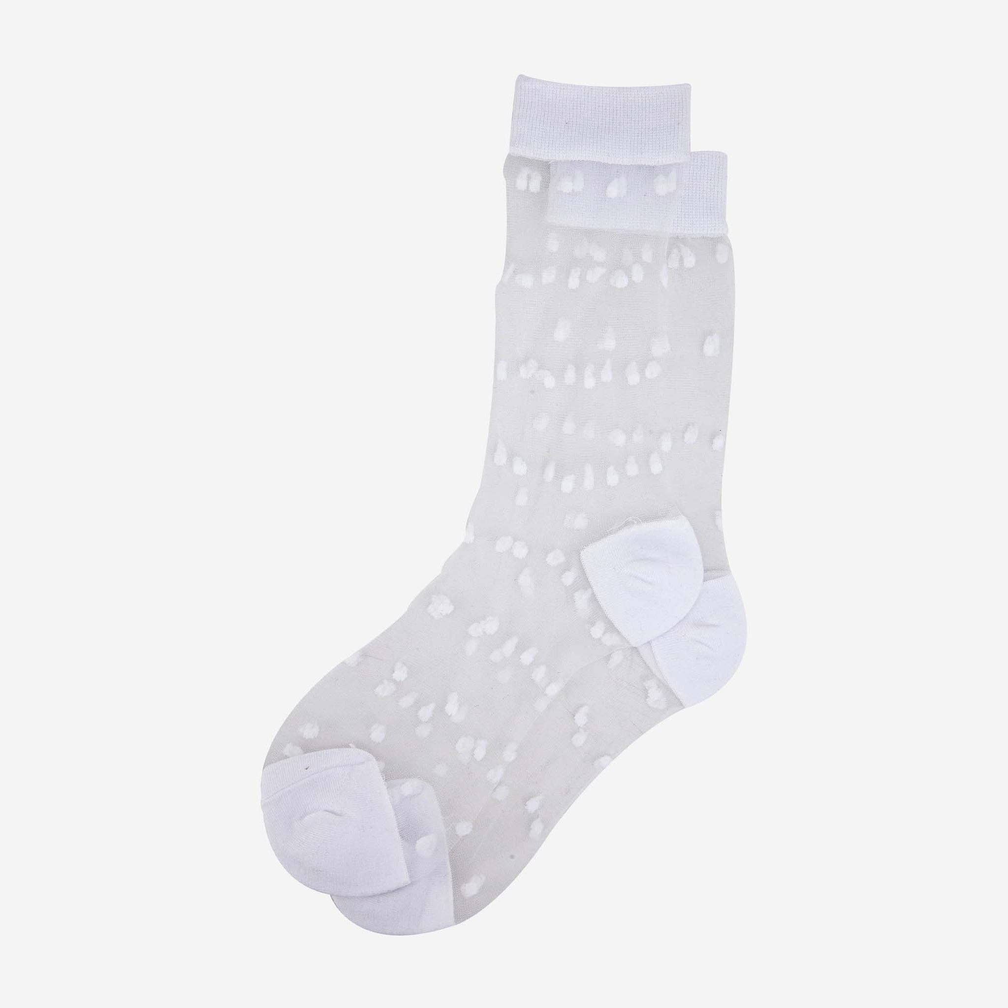 White sock with small polka dots on a light gray background