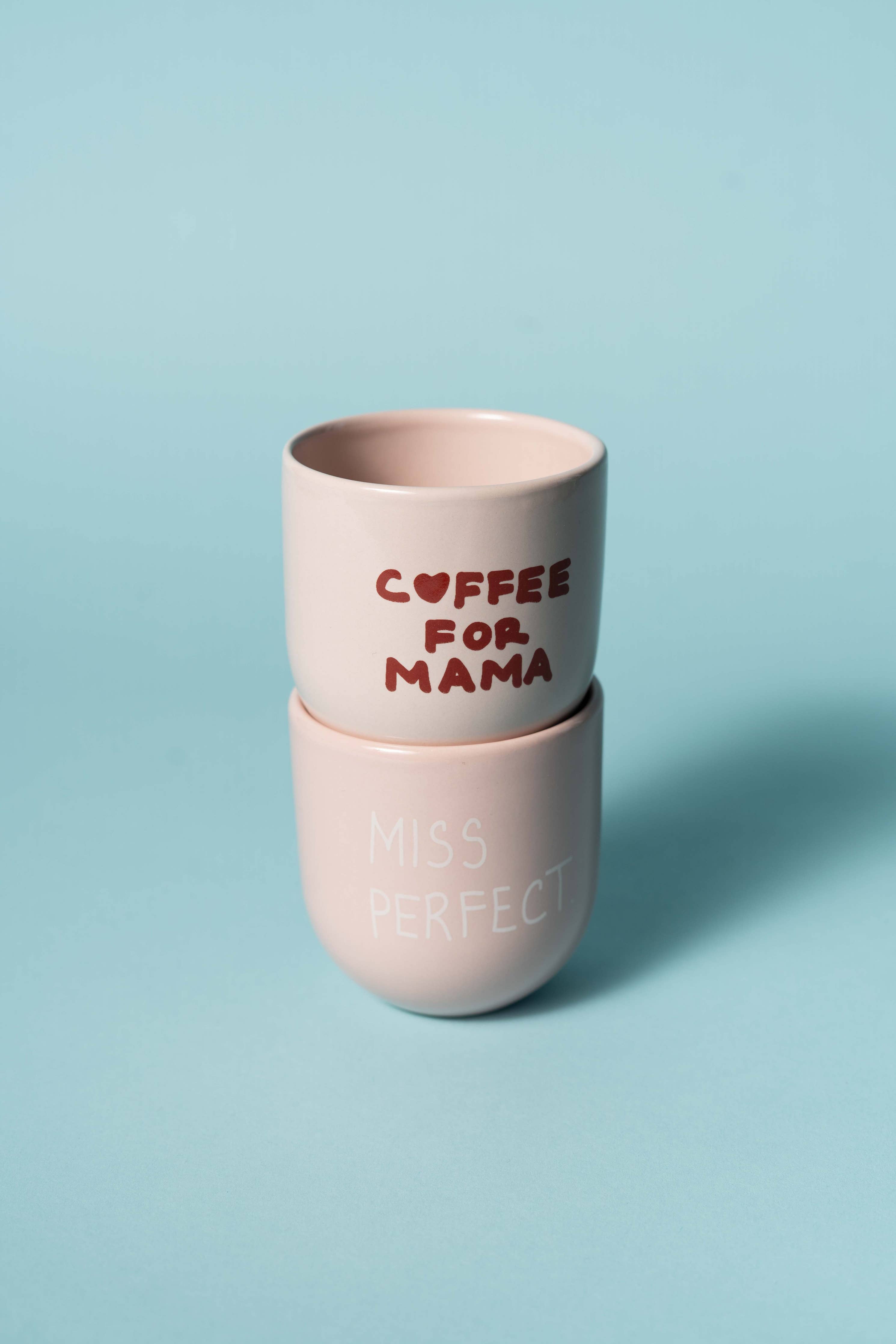 Two pink cups with text on a light blue background