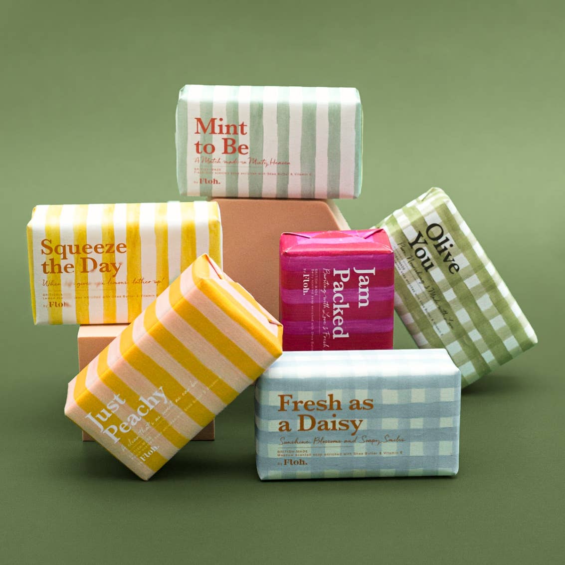 Assorted colorful soap bars with text on a green background