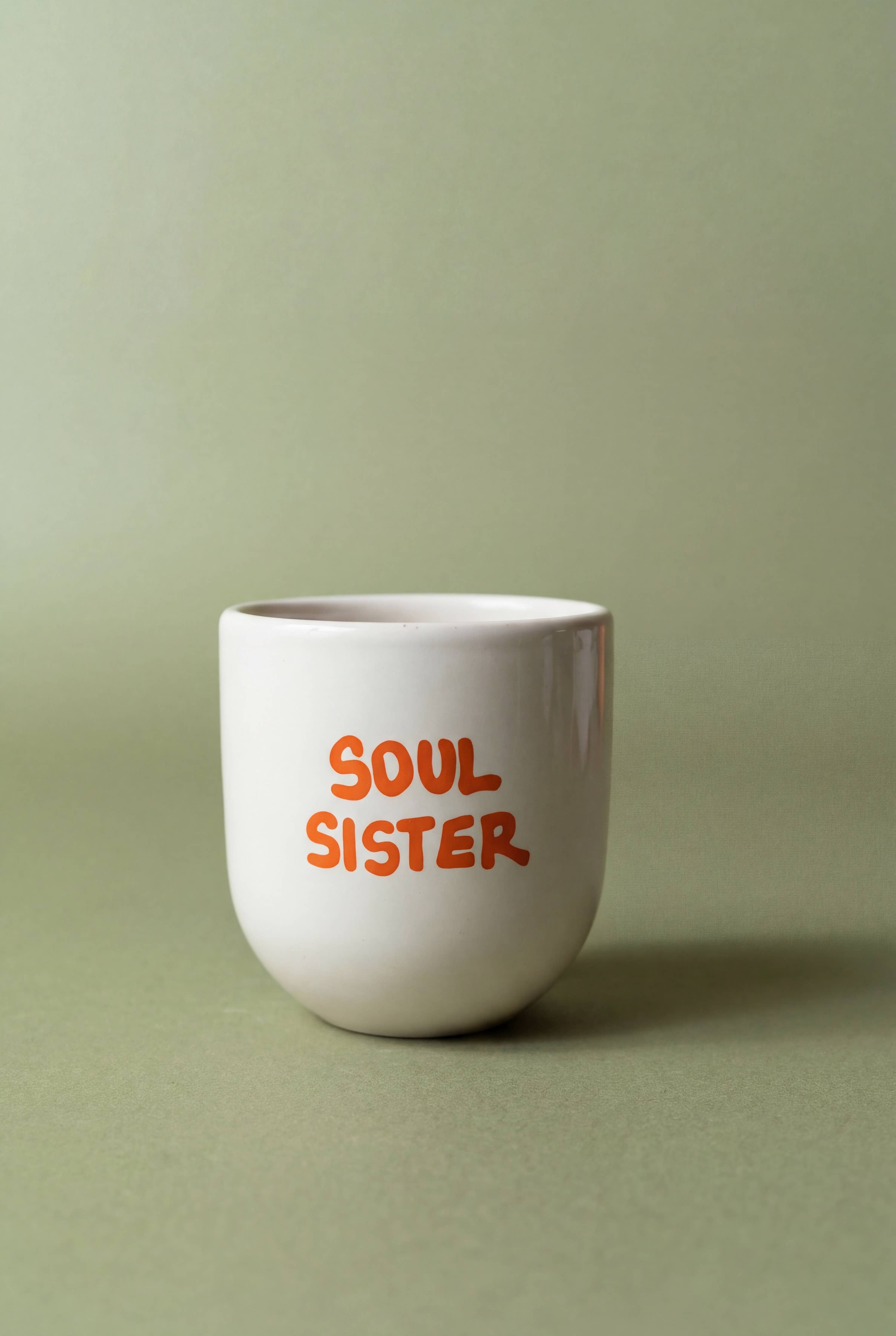 White mug with 'Soul Sister' text on a green background