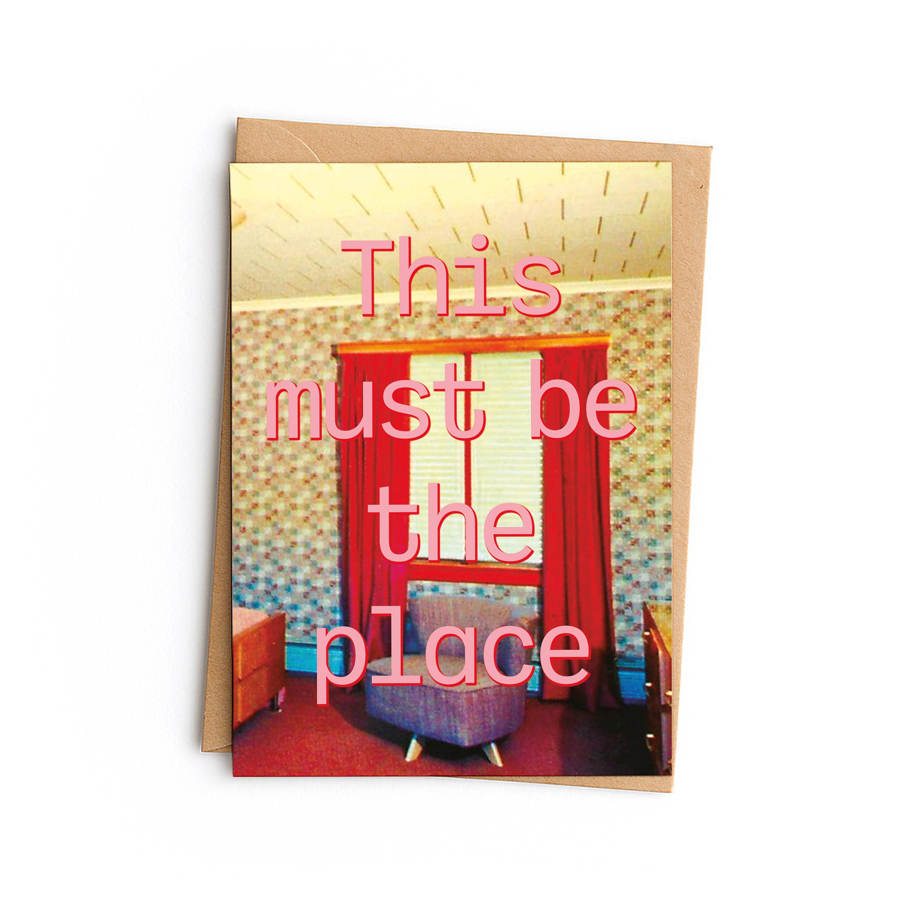 Greeting card with a retro interior design and text 'This must be the place' on a white background.