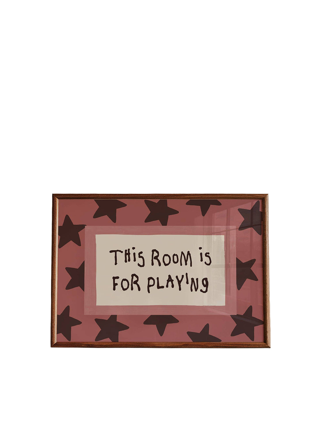 A framed art print featuring the text 'THIS ROOM IS FOR PLAYING' in black handwritten-style lettering on a cream background, surrounded by a dusty pink border with dark brown star shapes and a thin brown frame.