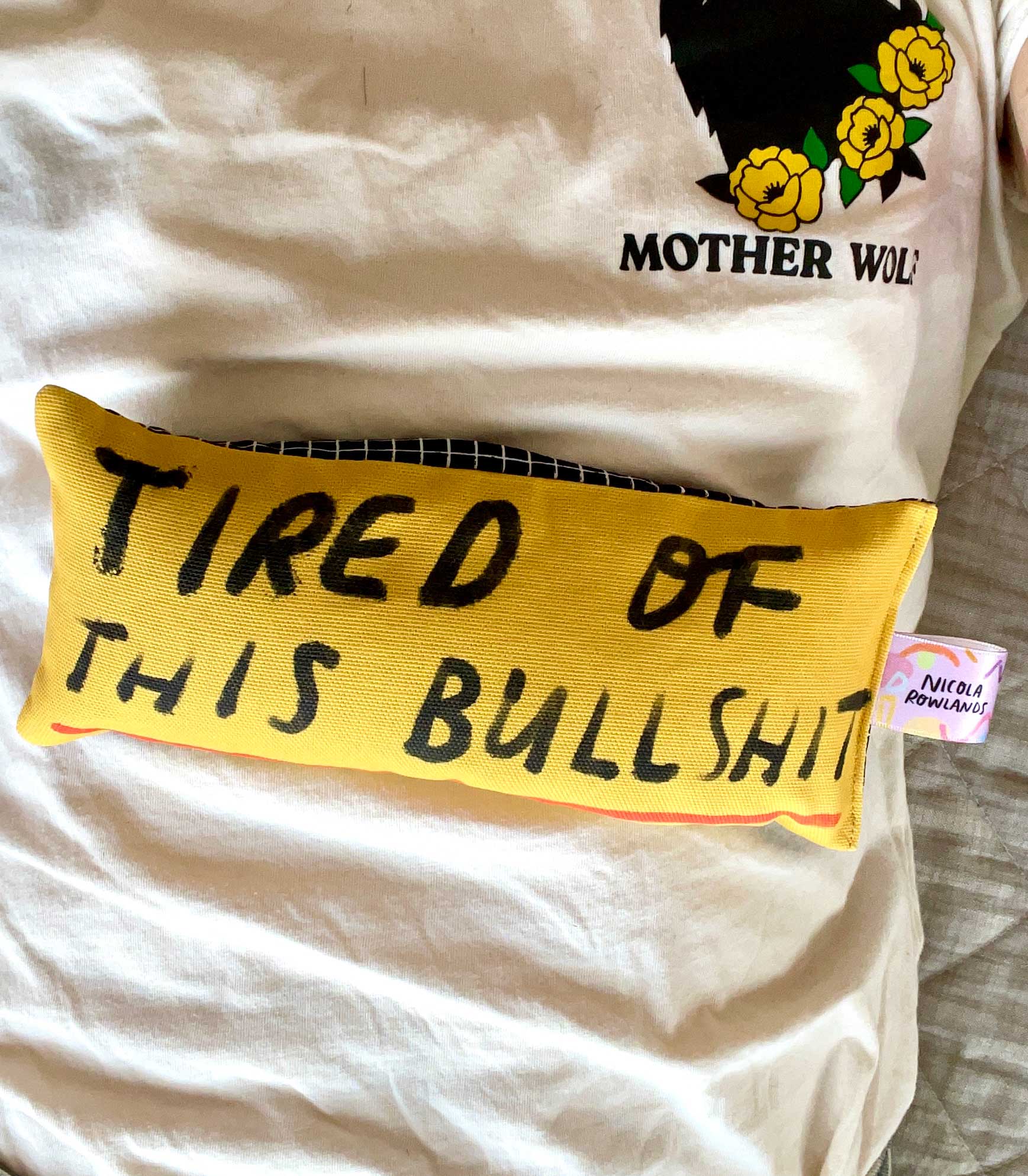 yellow eye bag with text that reads tired of this bullshit