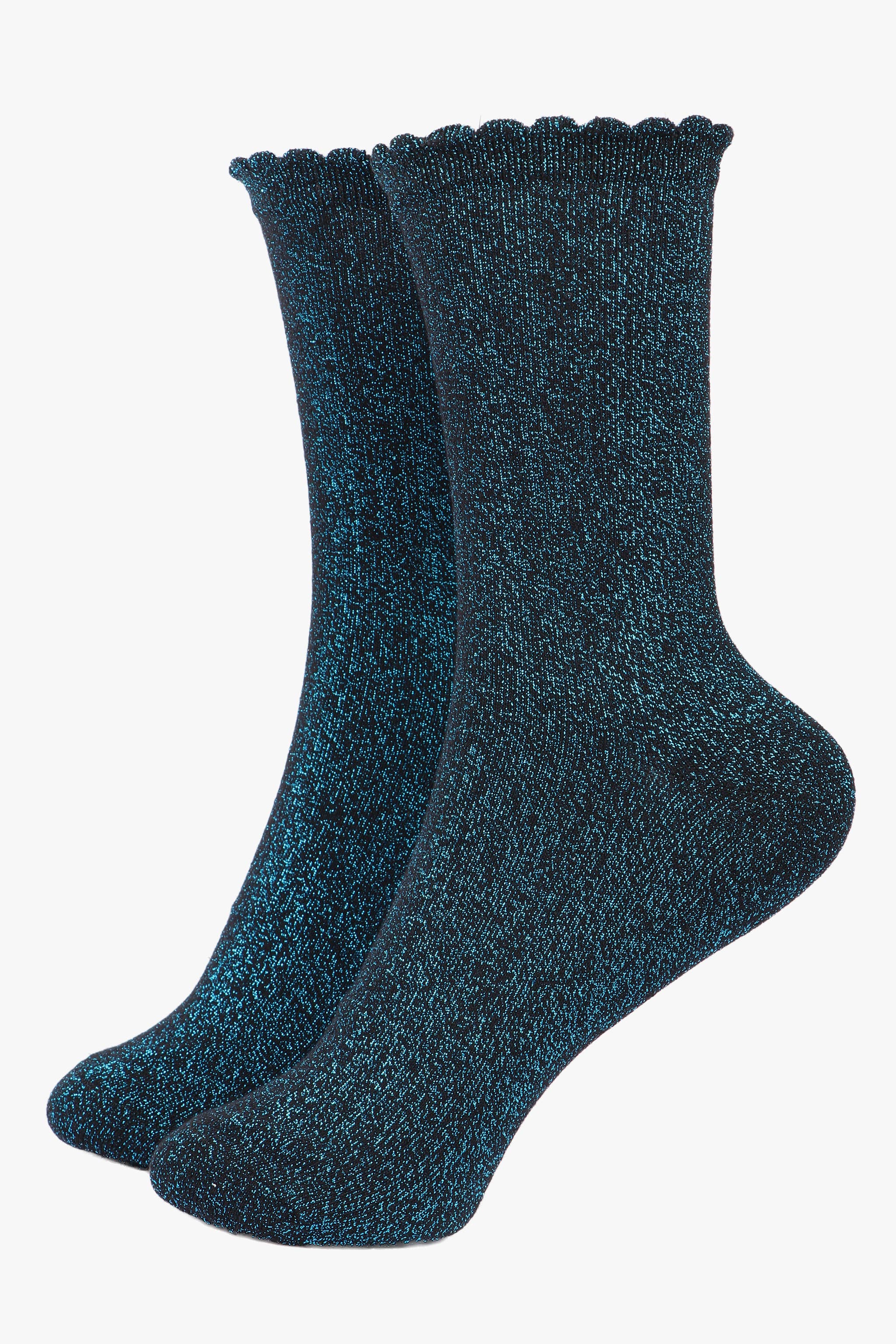 Pair of dark blue socks with scalloped edge on a white background