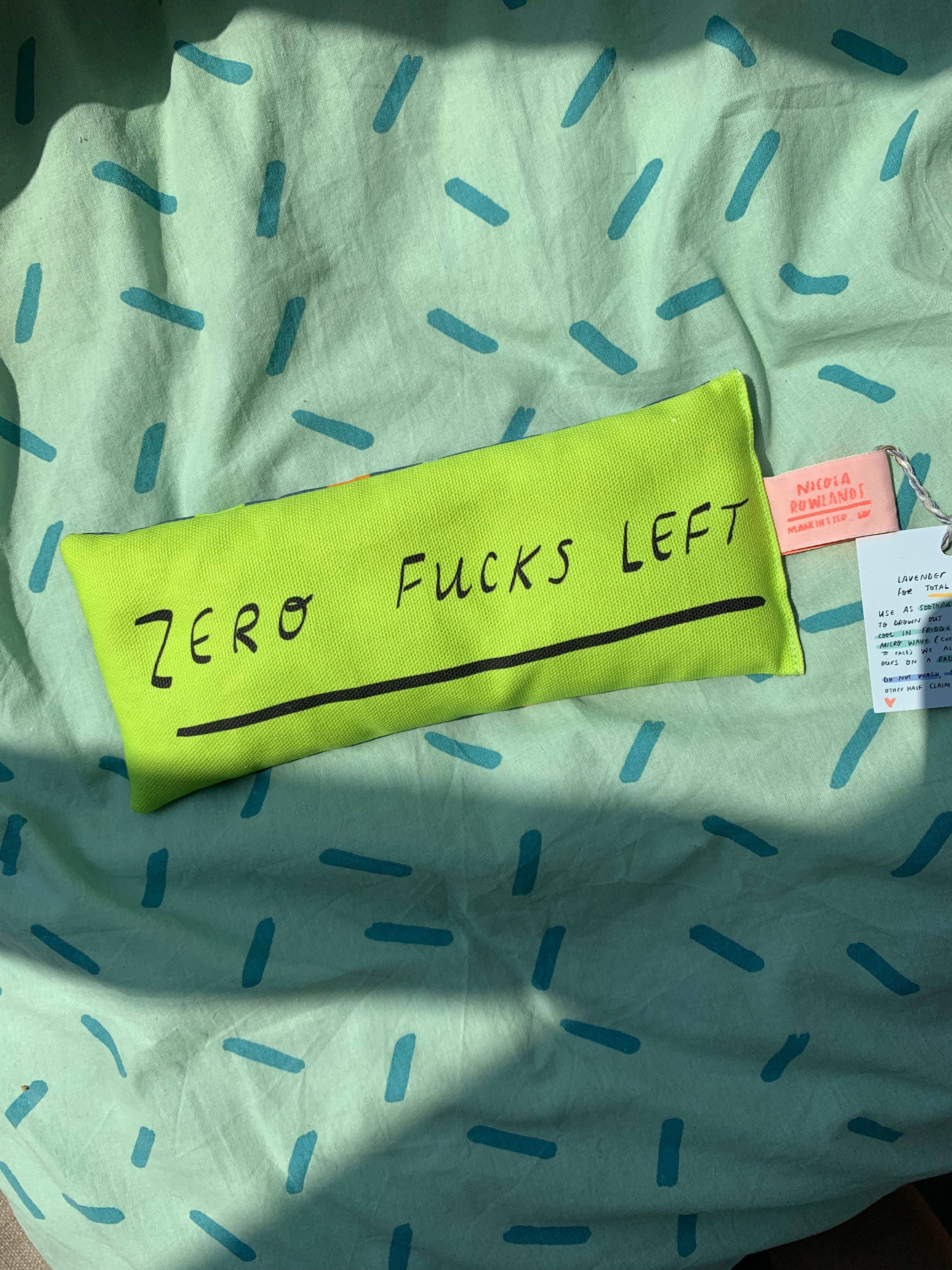 a green eye bag with the words zero fucks left